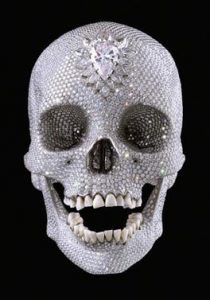 A silver bejeweled skull with an open mouth and large teardrop rhinestones set in the middle of the forehead.