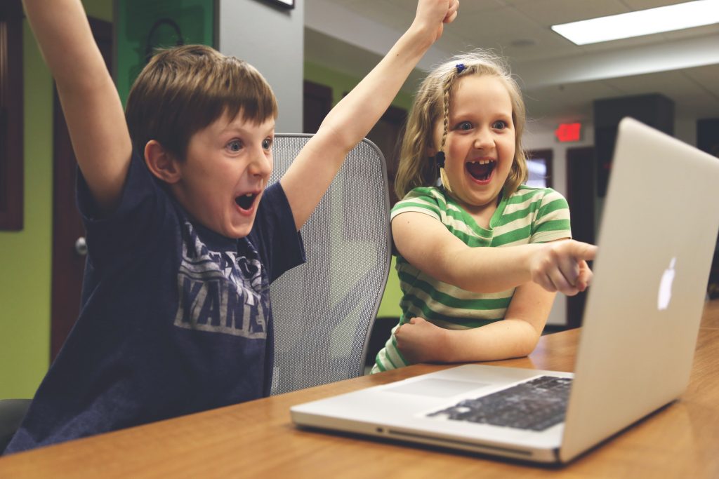 Boy and girl in front of a computer.