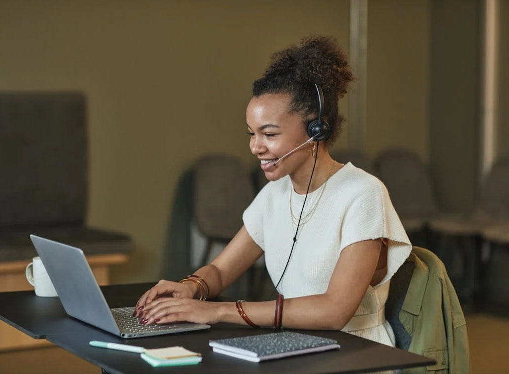 Woman conducting a computer-assisted phone interview.