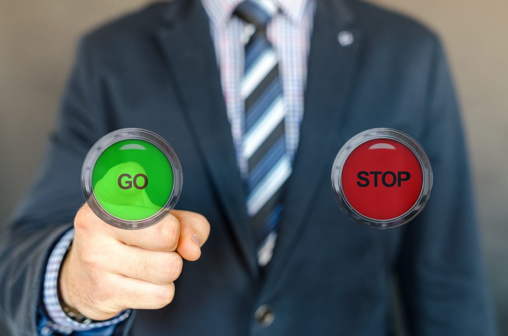 Person pushing a "go" button (with a choice of stop or go).