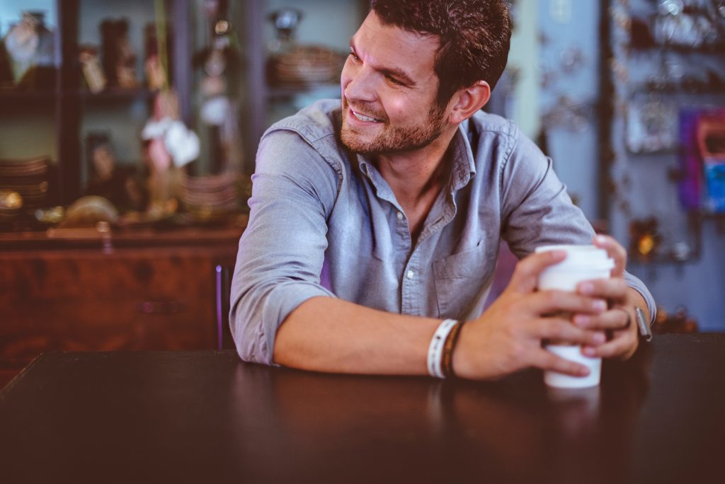 Man in his home having coffee.